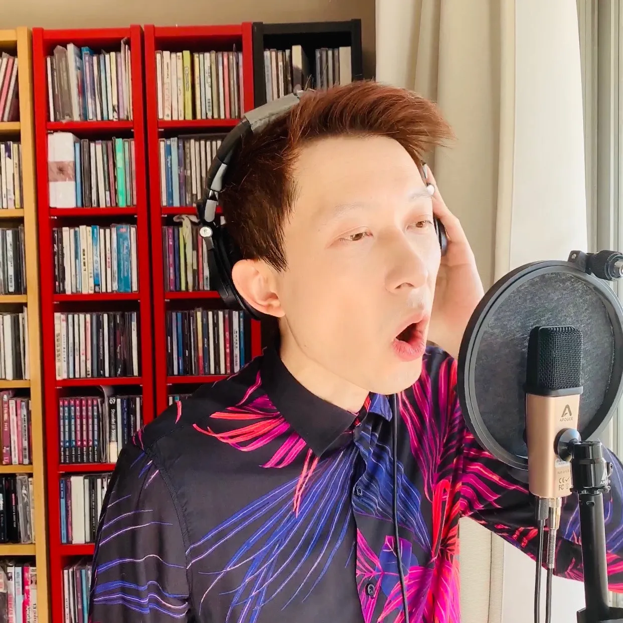 Cris Law singing into a studio microphone